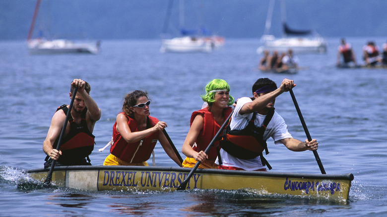 People rowing a concrete canoe on Lake Mendota