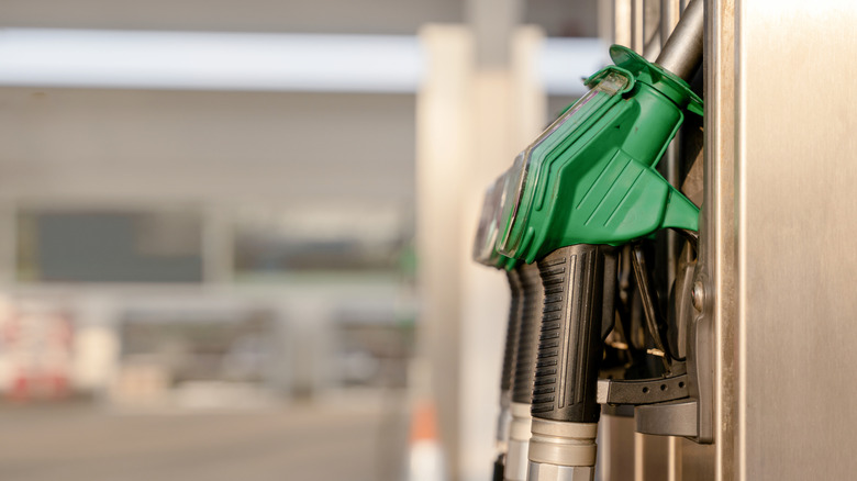 Gasoline and diesel fuel nozzles at a gas station.