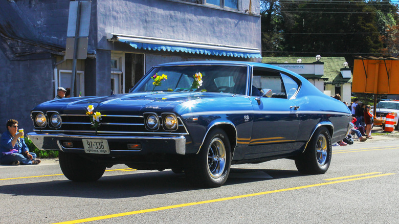 A blue 1969 Chevrolet Chevelle SS 396 driving down the road