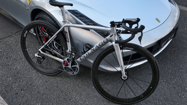 The Colnago V1-R carbon-fiber Ferrari bicycle leaning on a Ferrari car