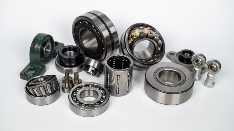 A selection of roller bearings sitting against a white background