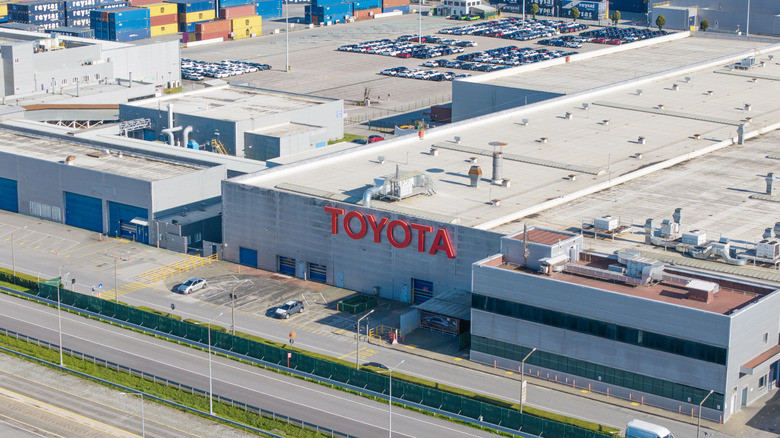 An aerial view of Toyota's manufacturing facility with cars and shipping containers outside