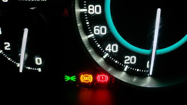A car instrument panel with illuminated ABS and brake warning lights