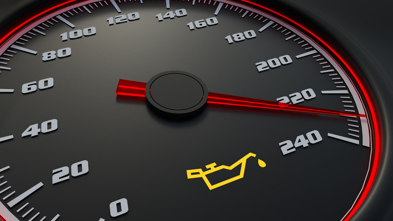 Illuminated oil light below a vehicle's speedometer