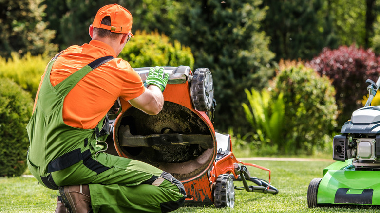 A technician inspecting a lawn mower