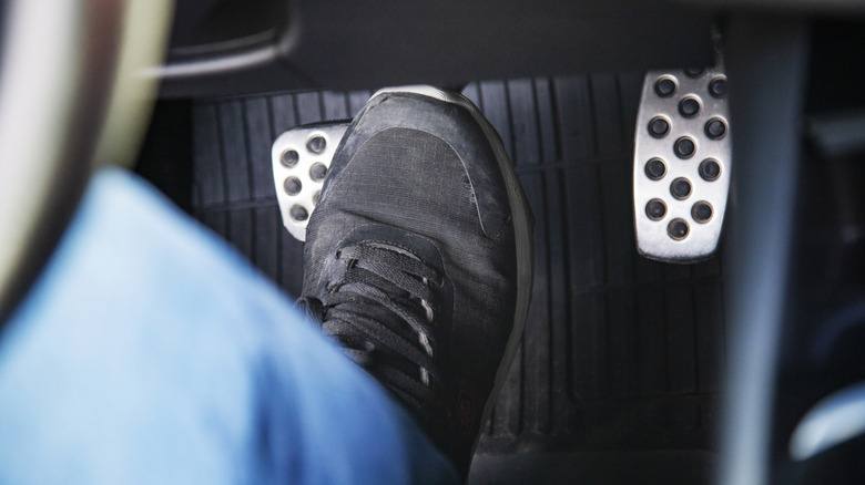 Driver pushing on the brake pedal