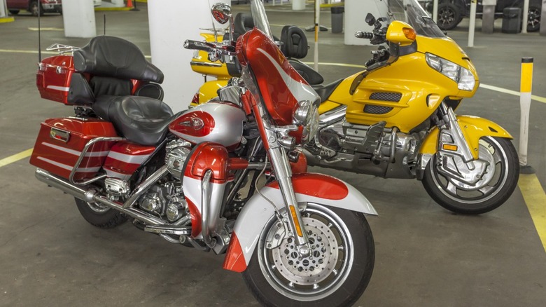 Red Harley-Davidson and yellow Honda Goldwing motorcycles.