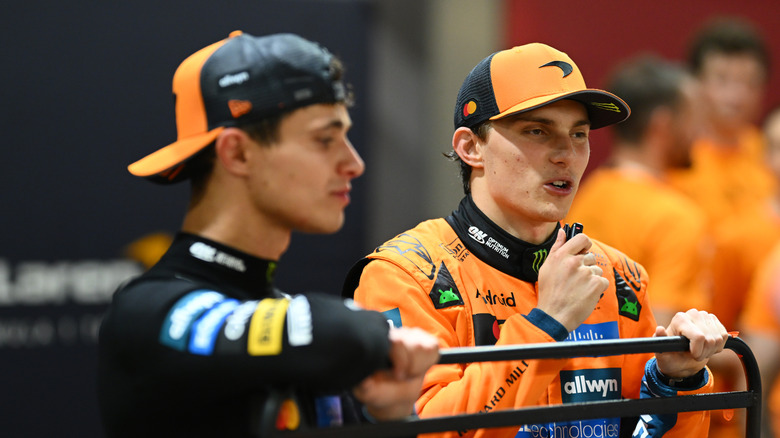 Lando Norris of Great Britain and McLaren and Oscar Piastri of Australia and McLaren celebrate with their team after winning the Constructors Championship during the F1 Grand Prix of Singapore at Marina Bay Street Circuit on October 05, 2025 in Singapore, Singapore.