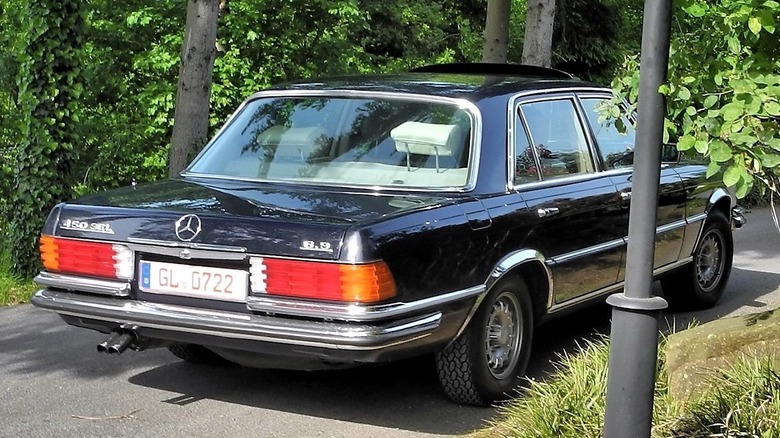 Rear view of a black Mercedes 450 SEL 6.9 with a German registration plate