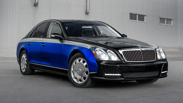 A front right 3/4 shot of a three-tone blue and black Maybach 57