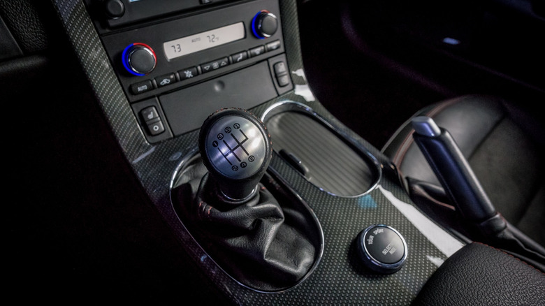 A black Corvette C7 parked, showing the gear shifter