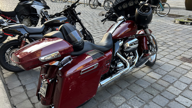 A couple of Harley-Davidson motorcycles parked on a cobblestone street