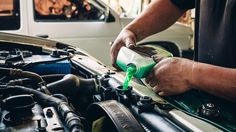 Pouring coolant into a reservoir