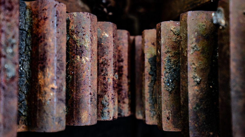 A set of old, worn, grime-covered, rusty gears