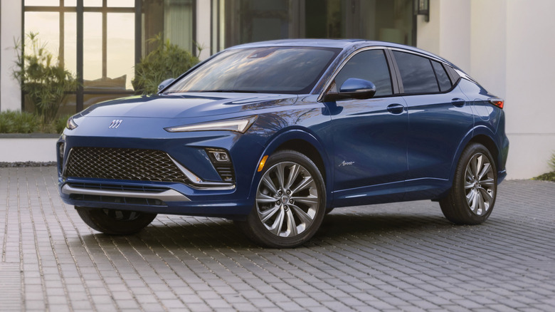 a blue Buick Envista parked on a cobblestone driveway
