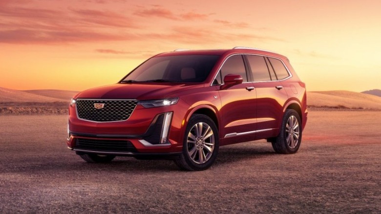 a red 2025 cadillac xt6 parked in the desert