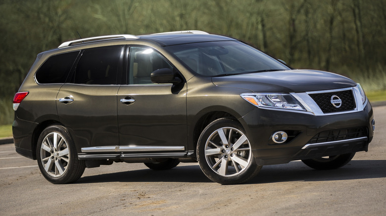 2016 Nissan Pathfinder parked on a paved surface with trees in the background