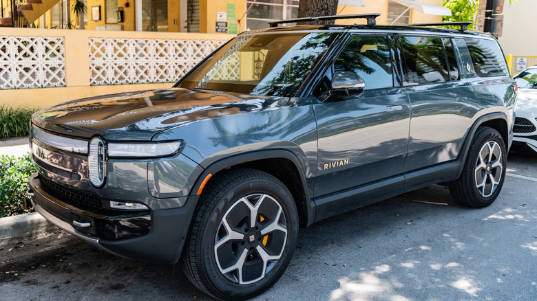 A gray Rivian R1S SUV parked on a street.