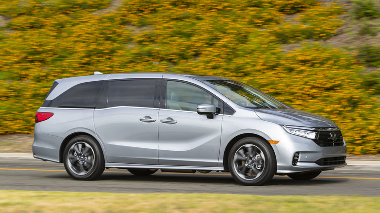 A silver 2022 Honda Odyssey being driven on a roadway.