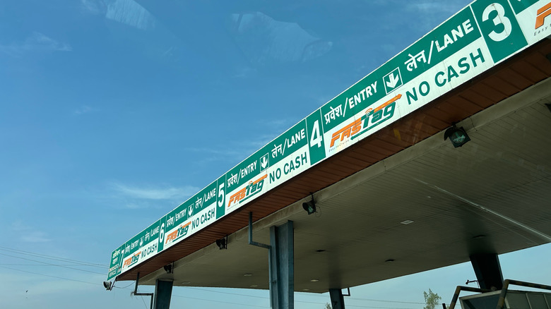 Fast Tag sign near a toll booth showing the new cashless RFID based FASTag payment system