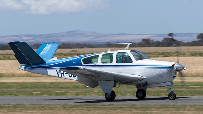 A Beechcraft Bonanza, also known as the 'Doctor Killer', taxiing on a dirt strip in Australia
