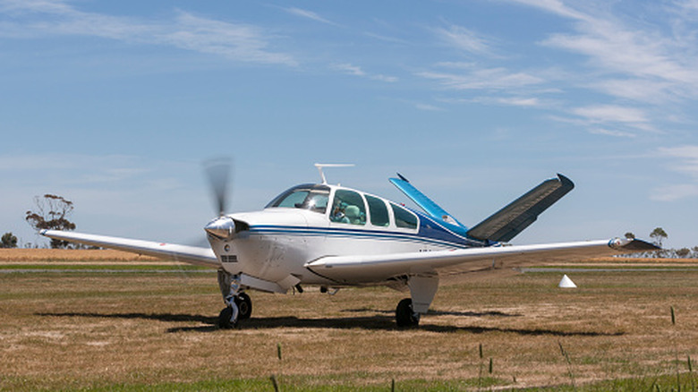 A Beechcraft V-35 Bonanza taxiing on a dirt strip in Australia