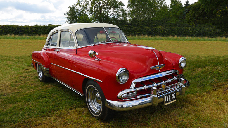 Classic 1952 Chevrolet Styleline parked in field.