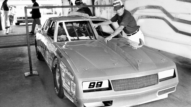 A NASCAR inspector uses a template on a Chevy racecar at Daytona Beach in 1986.