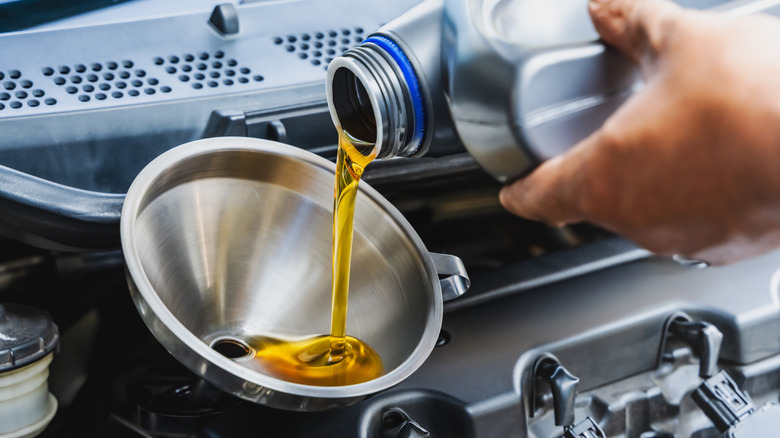 Mechanic pouring oil