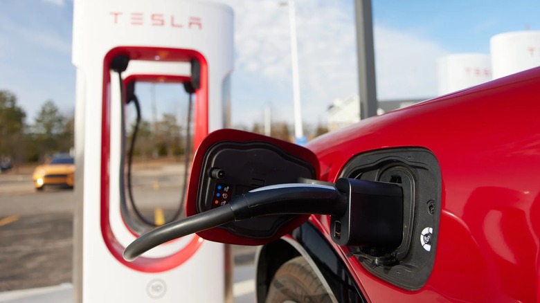 A Tesla Supercharger plugged into a Ford vehicle with a CCS adapter.