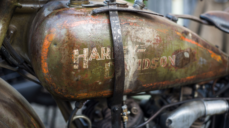 A closeup of a rusty Harley-Davidson showing off its fuel tank patina
