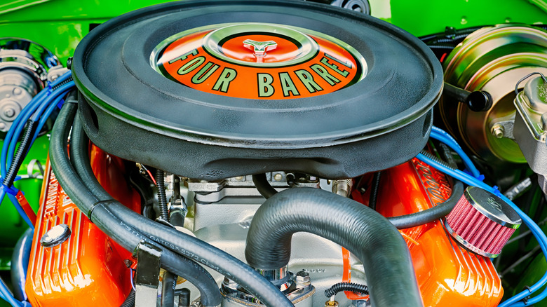 A four barrel carb on a vintage muscle car.