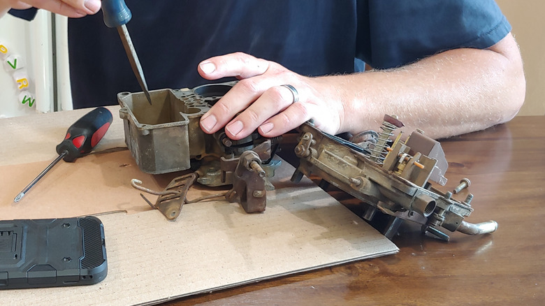 Removing carburetors to clean on the bench.