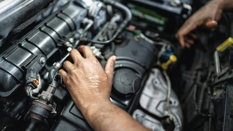 A mechanic working on an engine.