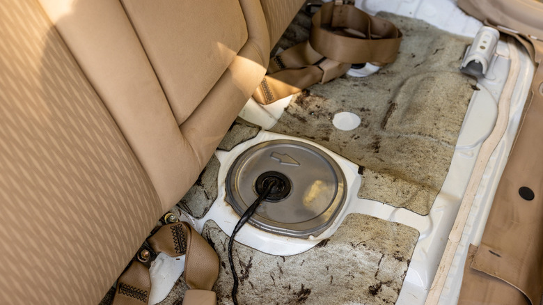 A fuel tank underneath a car's rear seat.