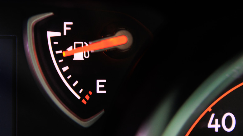 Fuel gauge pointing toward three quarters full in a car