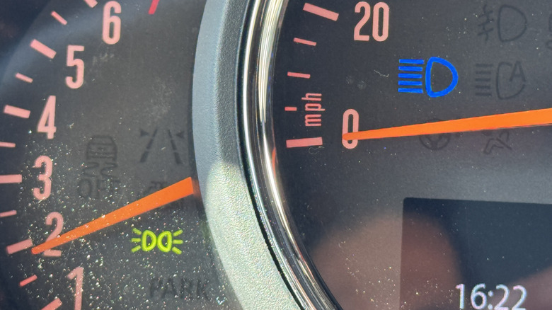 a close-up of the gauges in my Mini showing the blue high beam light