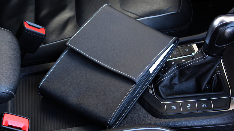 Leather service and hand-book holder lying next to gear selector