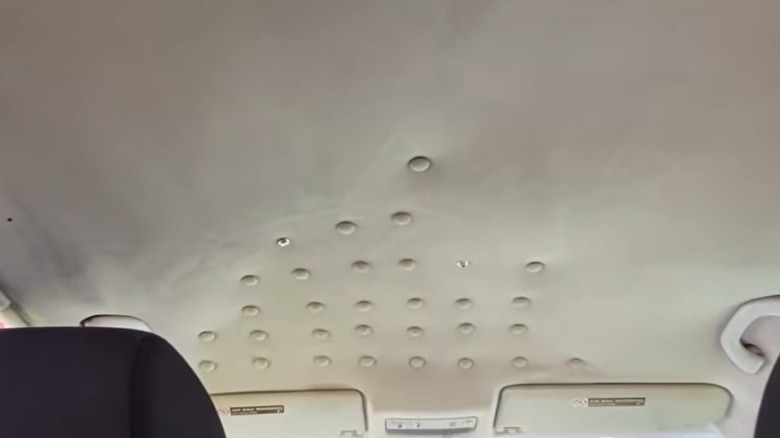 Snap rivets being applied to a saggy car ceiling