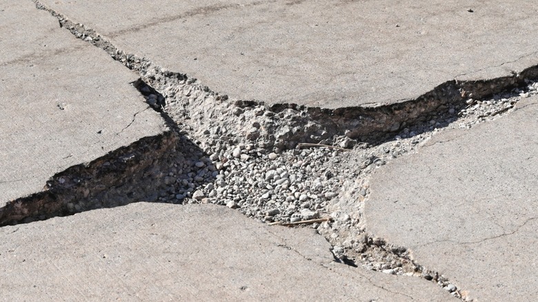 A pothole in a concrete driveway