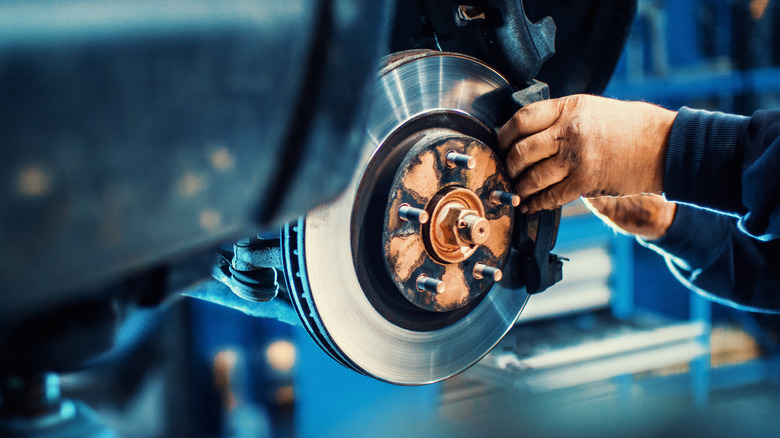 A mechanic doing a brake job on a car.