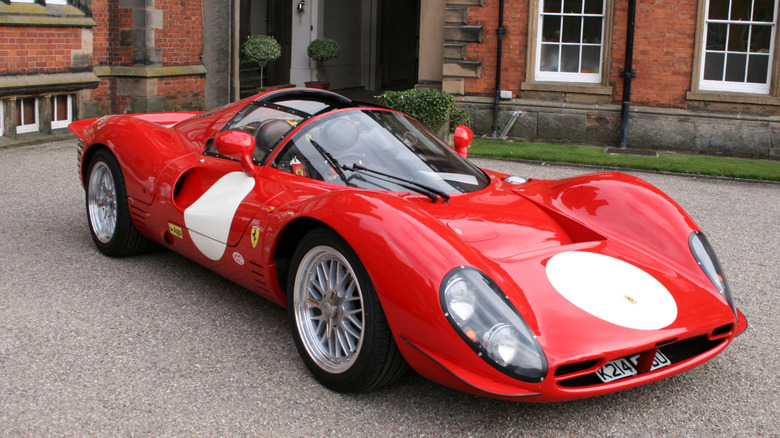 Red Ferrari 330 P4 replica sits parked outdoors.