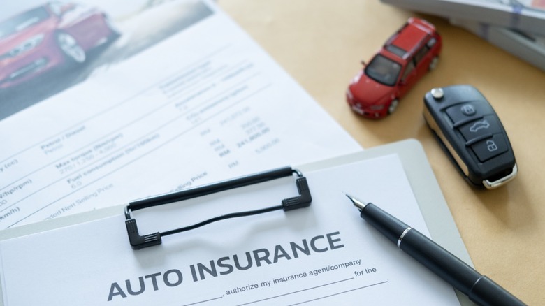 Clip board with automotive insurance papwersork