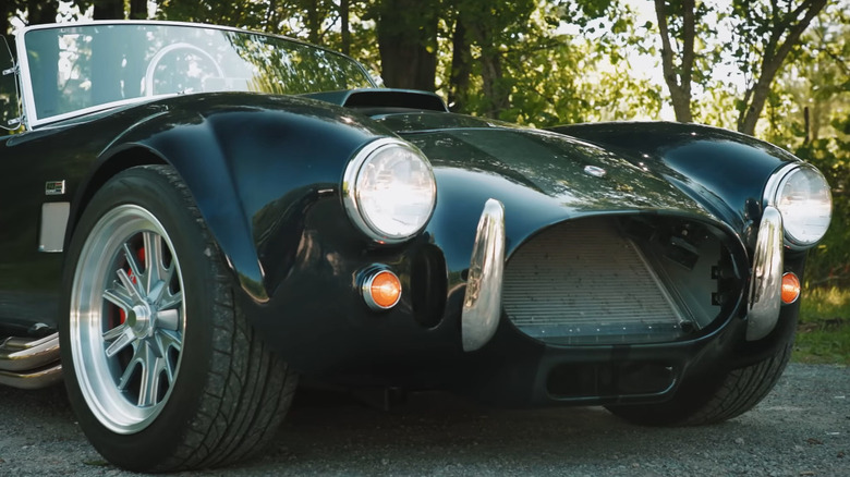 Front-quarter view of a dark green Factory Five Mk4 Roadster.