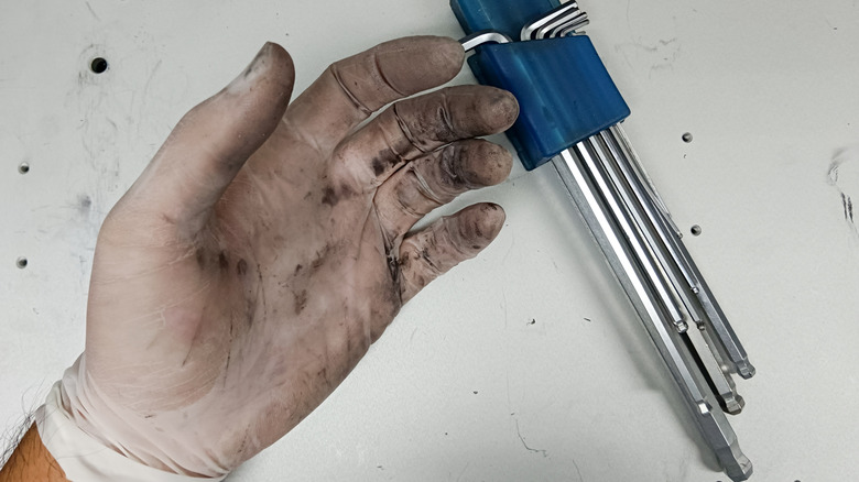 Stained achromatic rubber gloves aft moving connected a car