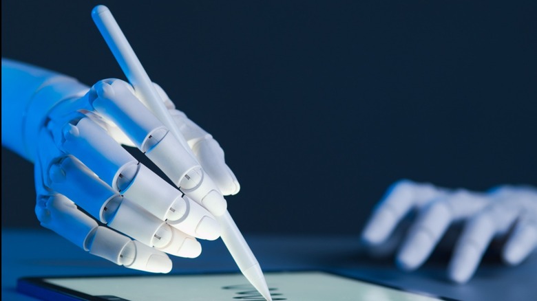 Robot hand writing on a tablet
