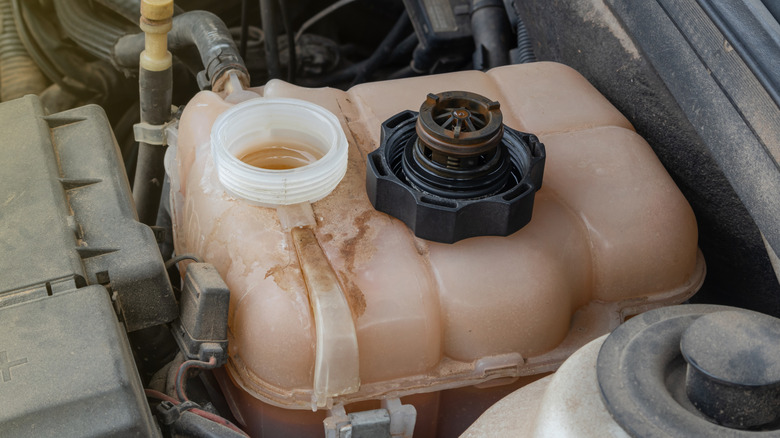 Old and dirty coolant inside a car's reservoir