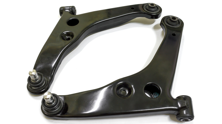 A pair of front control arms on display