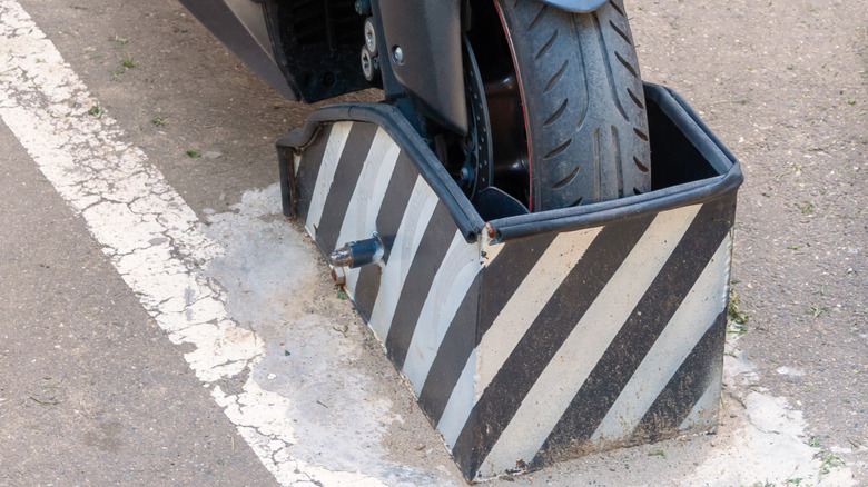 A motorcycle with its front wheel blocked by a wheel chock