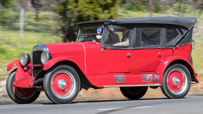 A brightly colored 1924 Maxwell Good Touring car driving on South Australian back roads